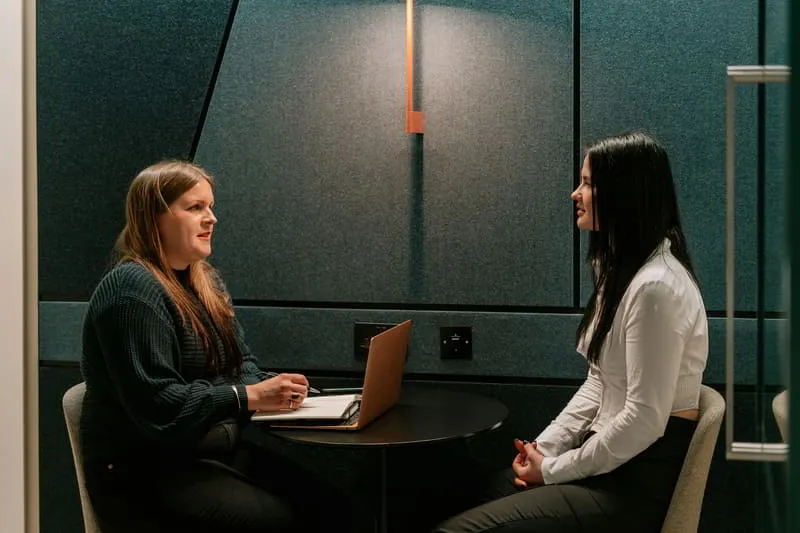 Research recruiter conducting a one-on-one qualitative interview with a professional participant