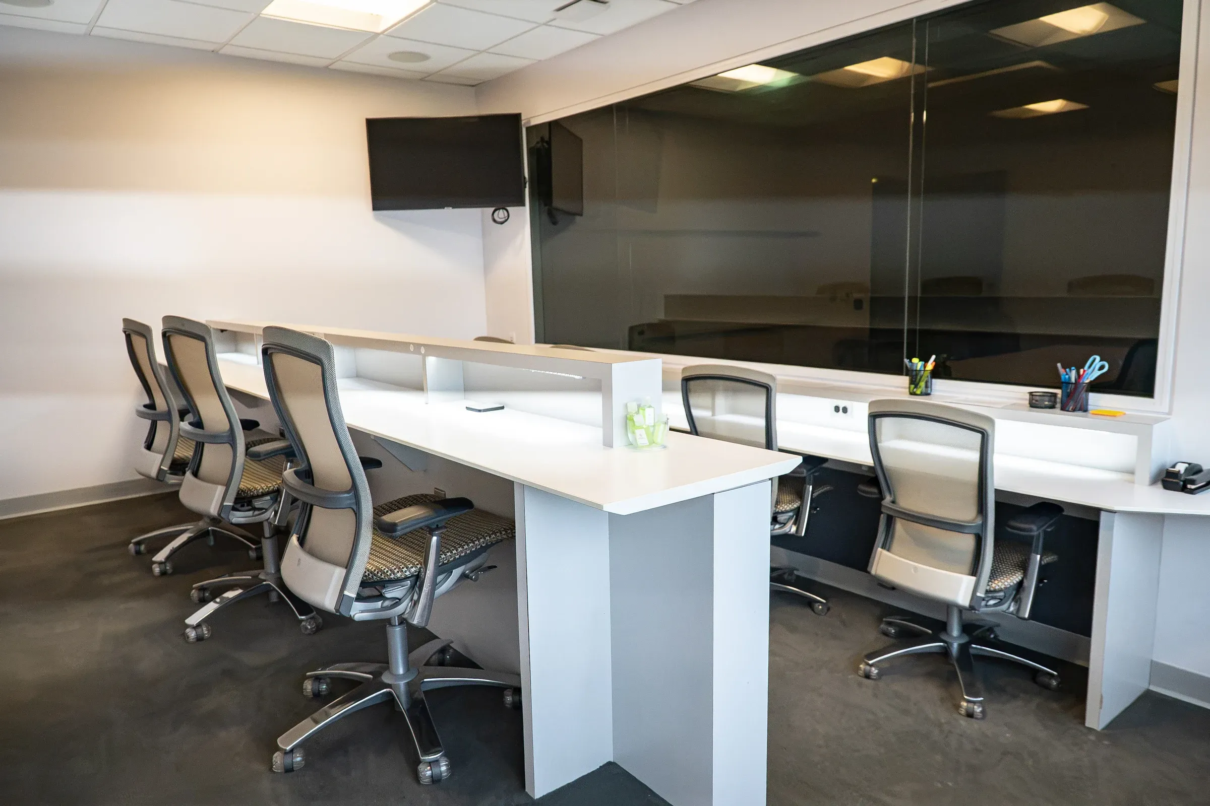 Highlands Suite viewing room with tiered desks and a one-way mirror