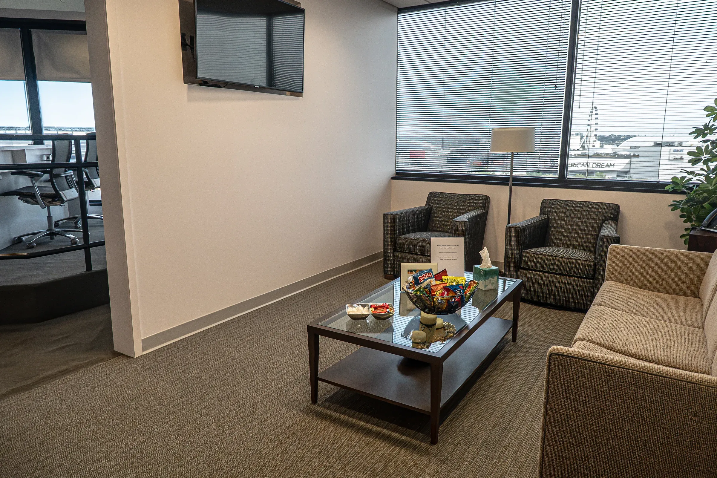 Stadium Suite private lounge with sofa, armchairs, and a coffee table